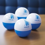 Blue and white stress balls with uniform branding at the top of each
